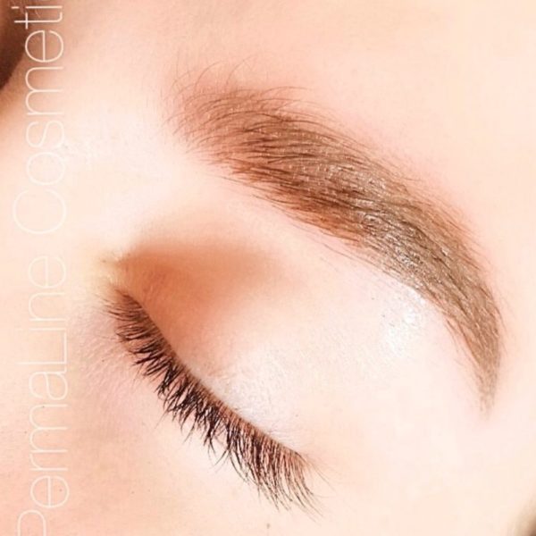 A close up of a woman's eye with eyebrows.