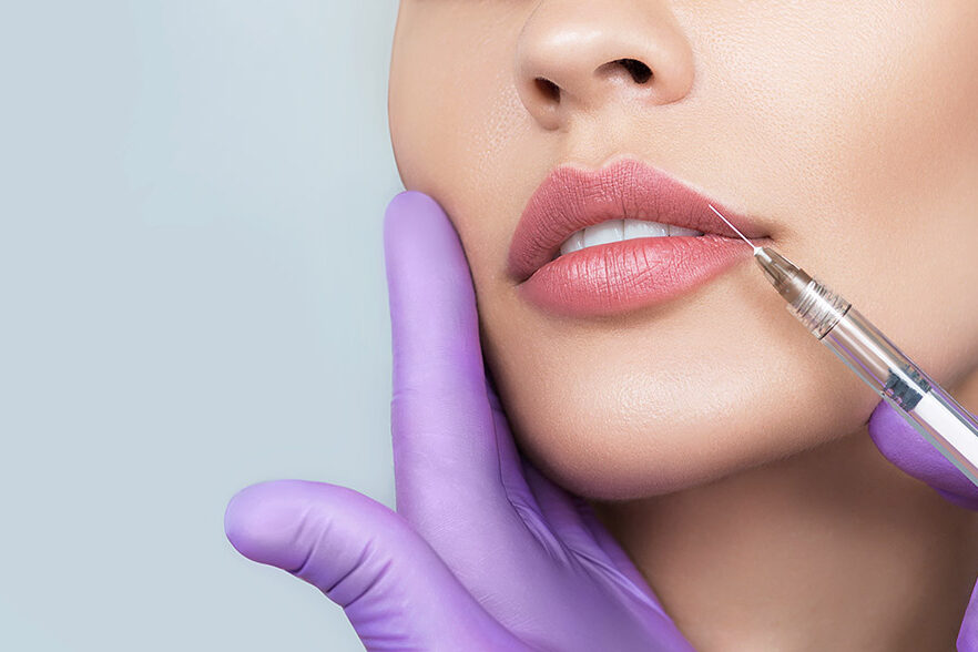 enhancing-your-natural-beauty-with-dermal-fillers-and-botox A woman is getting a lip injection.