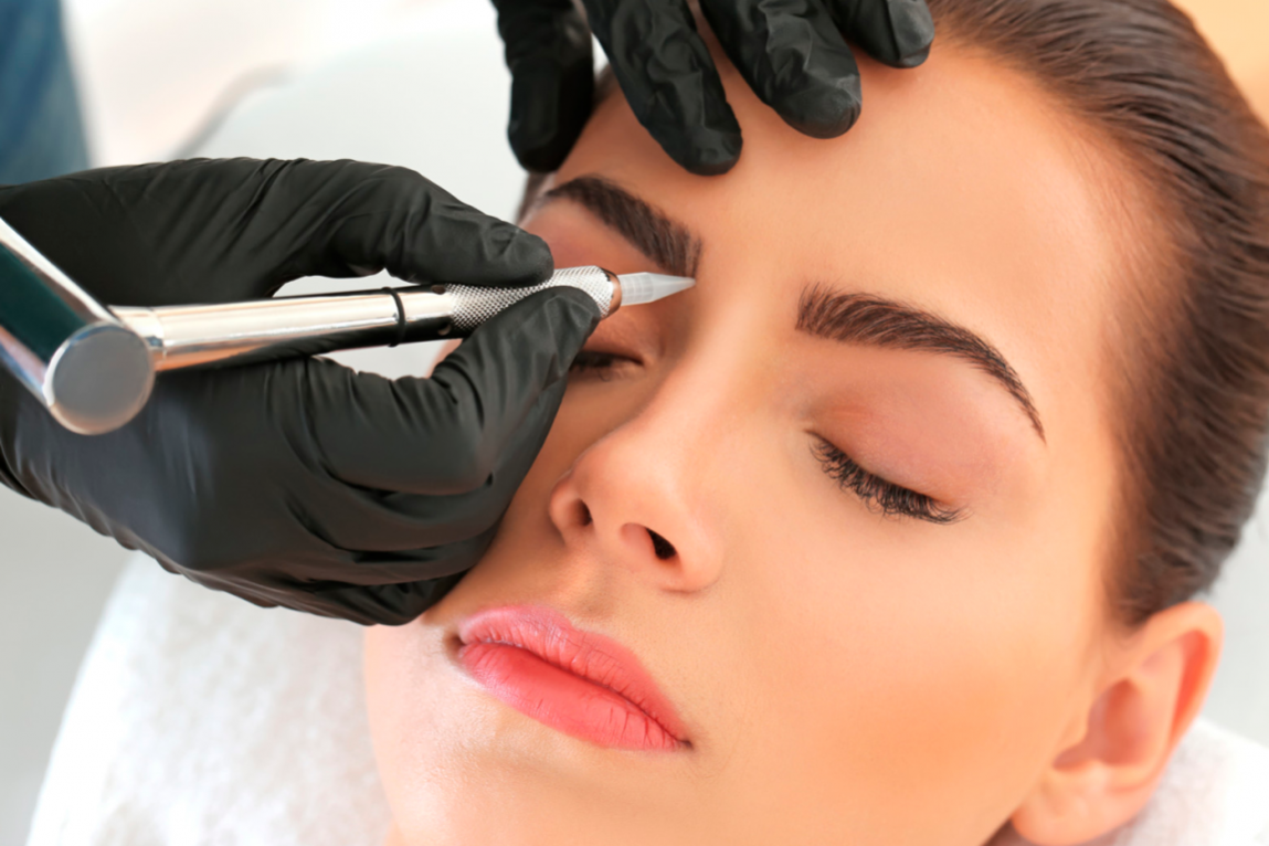 A woman getting her eyebrows done in a salon.
